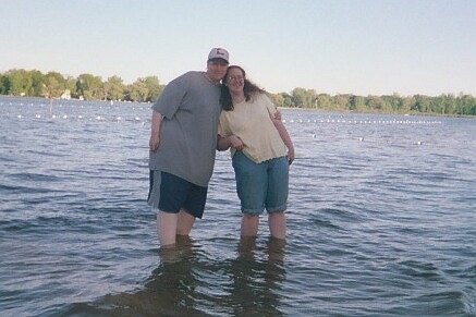 Frank and Cindy stand in the waters of Lake Lansing